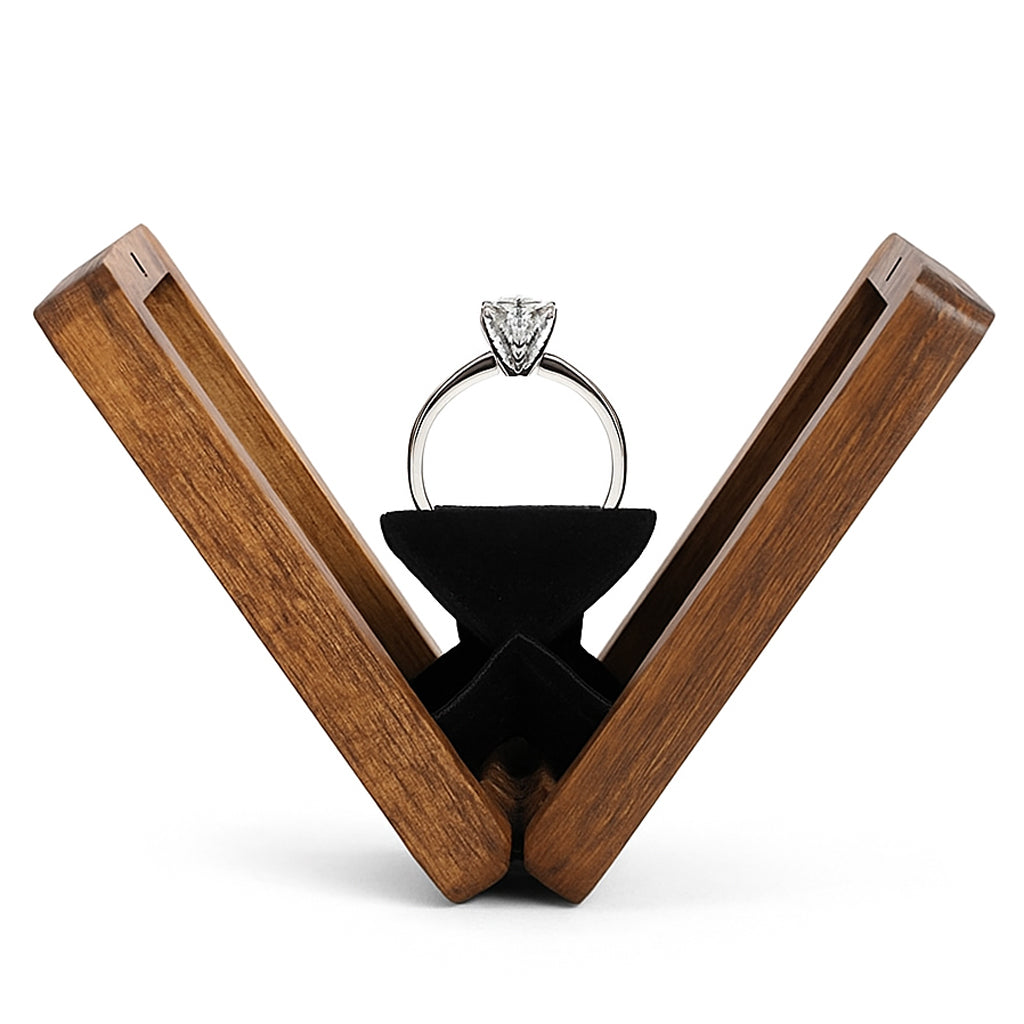 Diamond engagement ring displayed in open wooden ring box