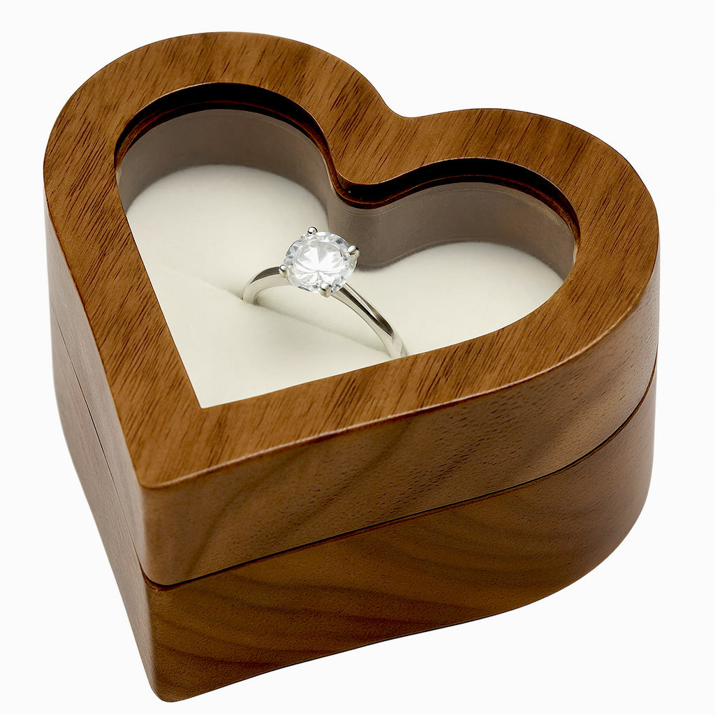 Wooden heart shaped ring box with glass lid holding diamond engagement ring