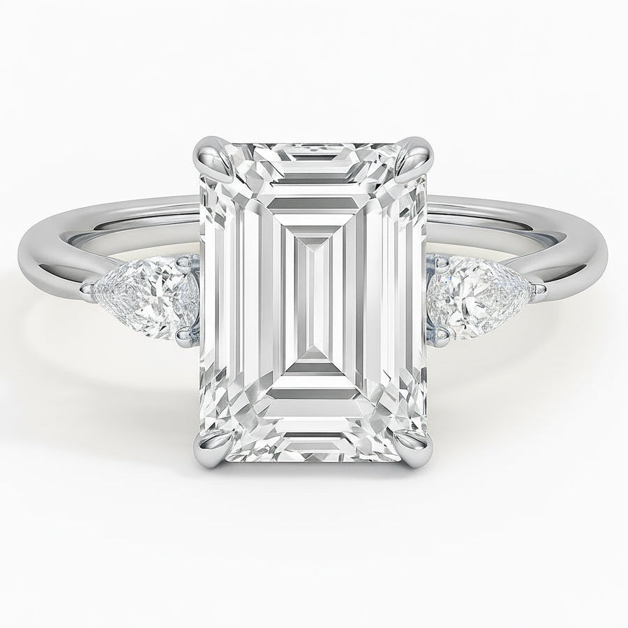 Emerald cut diamond white gold three-stone pear engagement ring front view