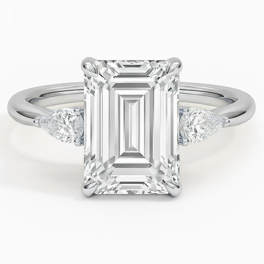 Emerald cut diamond white gold three-stone pear engagement ring front view