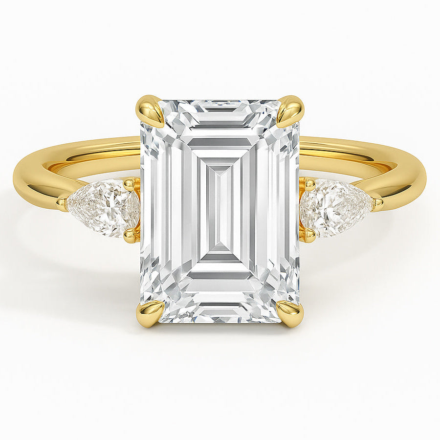 Emerald cut diamond yellow gold three-stone pear engagement ring front view