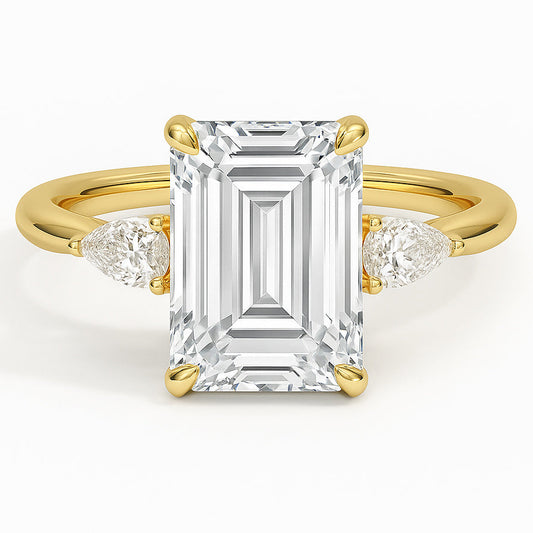 Emerald cut diamond yellow gold three-stone pear engagement ring front view