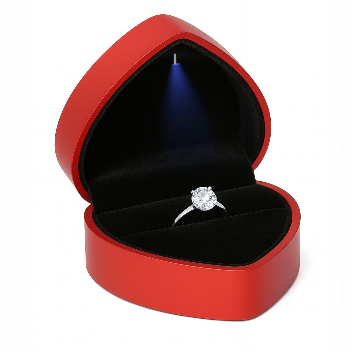 Open red heart shaped ring box with LED light holding engagement ring