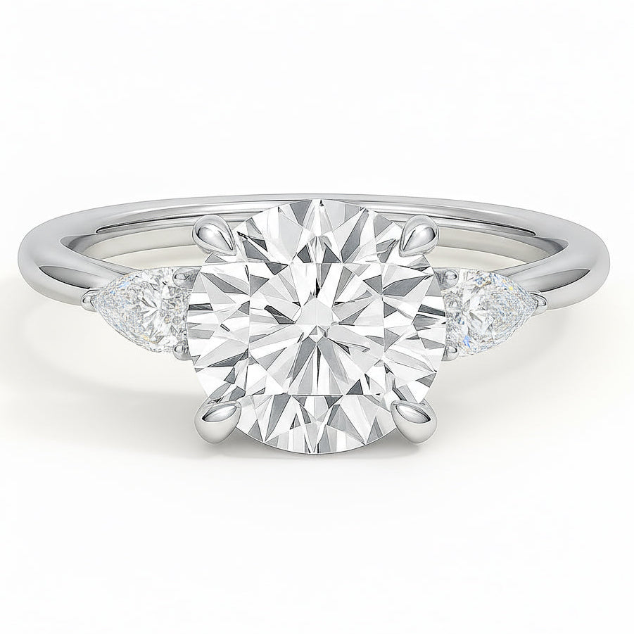 Round cut diamond white gold three-stone pear engagement ring front view